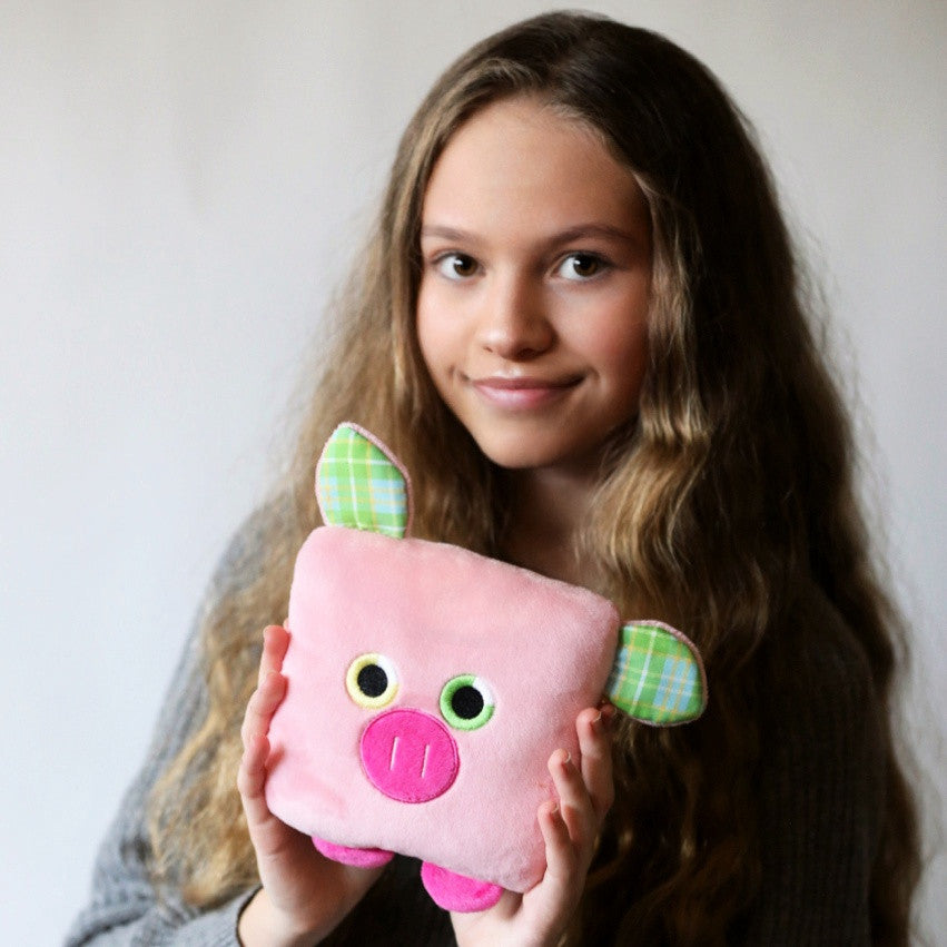 Plush toy pig stuffed animal with a useful back pocket, designed by young entrepreneurs